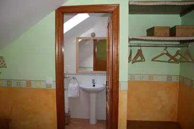 a bathroom with a sink and a mirror at El Aposento De Babia in Quintanilla De Babia