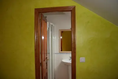 a bathroom with a sink and a mirror at El Aposento De Babia in Quintanilla De Babia