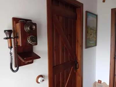 an open door with a camera on a wall at Stone Cottage SANTIAGO in Curtis