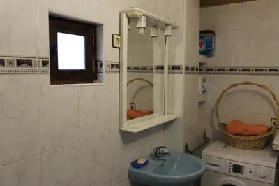 a bathroom with a sink and a mirror at La Puchera in Cangas del Narcea