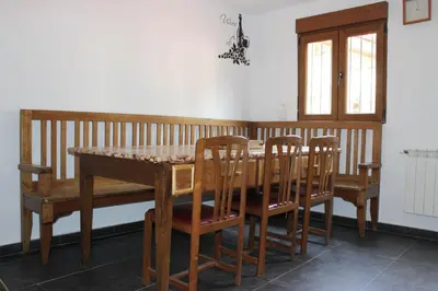 a kitchen with wooden cabinets and a sink at La Puchera in Cangas del Narcea