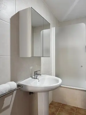a white bathroom with a sink and a mirror at Lemos Nube in Monforte de Lemos