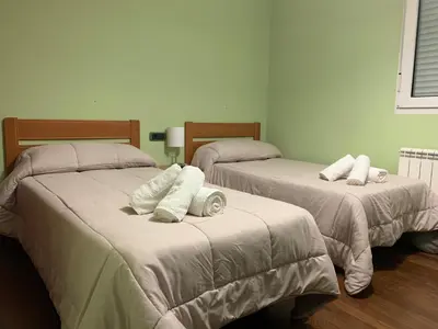a room with two beds with pillows on them at Oktheway San Eufrasio in Sarria