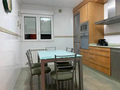 a kitchen with a table and chairs in it at Oktheway San Eufrasio in Sarria