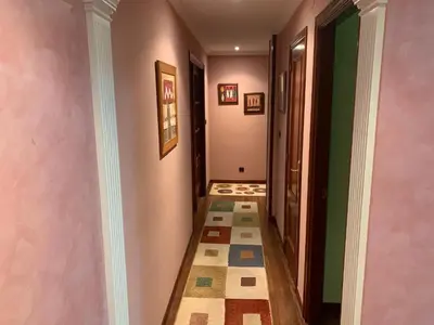 a hallway with pink walls and a patterned floor at Oktheway San Eufrasio in Sarria