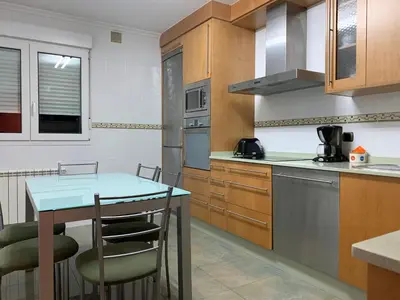 a kitchen with a table and chairs in it at Oktheway San Eufrasio in Sarria