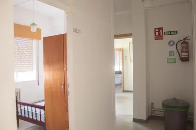 a room with a hallway with a door and a hallway at Albergue Santa Olaia in Silleda
