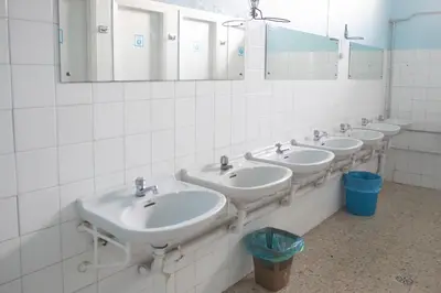 a row of sinks in a bathroom with mirrors at Albergue Santa Olaia in Silleda
