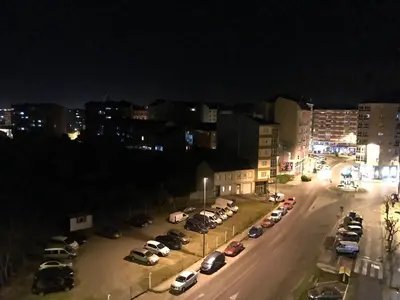 a city street at night with cars parked at lucushouse I in Lugo