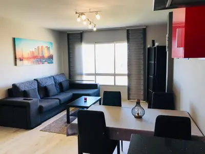a living room with a blue couch and a table at lucushouse I in Lugo