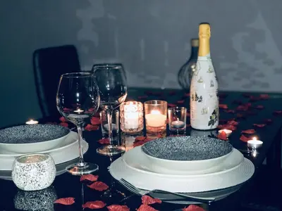 a table with plates and wine glasses and a bottle at lucushouse I in Lugo