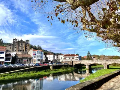 a bridge over a river in a city at Apartamento Padrón Centro P1 by URent in Padrón