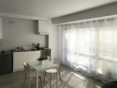 a kitchen with a table and chairs and a window at Apartamento Padrón Centro P1 by URent in Padrón