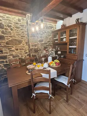 a dining room with a wooden table and chairs at Casa Tarrío con Piscina - Santiago de Compostela in Boqueijón