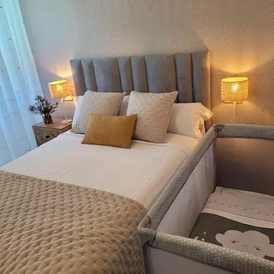 a large bed in a bedroom with two lamps at Casa Tarrío con Piscina - Santiago de Compostela in Boqueijón