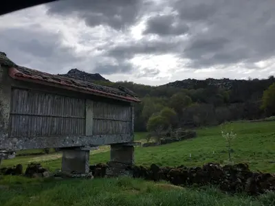 an old building sitting in a field in a field at A Casa do Chico in Ourense