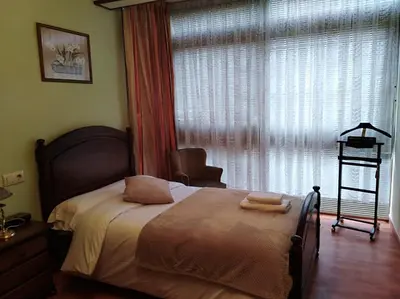 a bedroom with a bed with two towels on it at jucar carmen in Santiago de Compostela