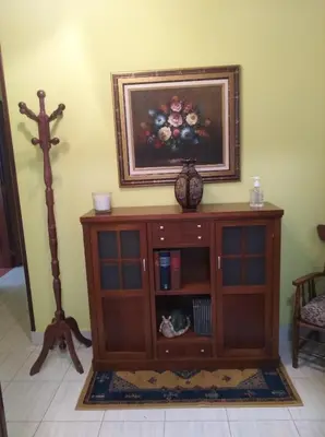 a wooden cabinet in a room with a picture on the wall at jucar carmen in Santiago de Compostela