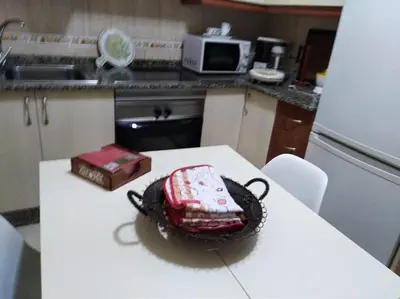 a cake sitting on top of a table in a kitchen at jucar carmen in Santiago de Compostela