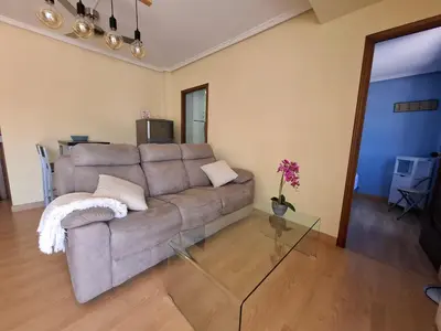 a living room with a couch and a glass table at Luna - Disfruta de Ourense en este piso con terraza en el casco histórico in Ourense