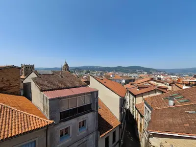 a view of the roofs of a city at Luna - Disfruta de Ourense en este piso con terraza en el casco histórico in Ourense