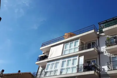 an apartment building with balconies and a blue sky at Luna - Disfruta de Ourense en este piso con terraza en el casco histórico in Ourense