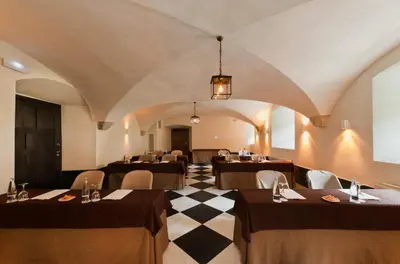 a restaurant with tables and chairs in a room at Parador de Corias in Cangas del Narcea