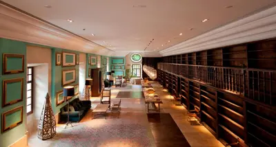 a library with lots of bookshelves and a hallway at Parador de Corias in Cangas del Narcea