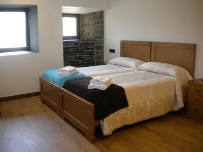 a bedroom with two beds with towels on them at Casa de Aldea Araceli in Berducedo