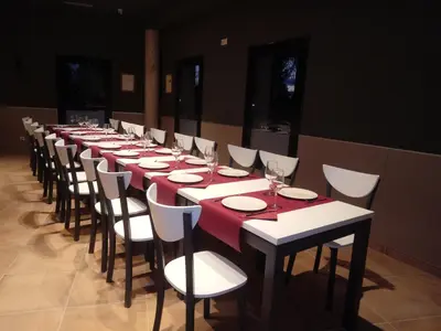a long table with chairs and wine glasses on it at TEIRABOA BASE CAMP in Arzúa