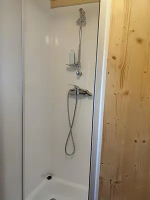 a shower in a bathroom with a sink and a toilet at TEIRABOA BASE CAMP in Arzúa