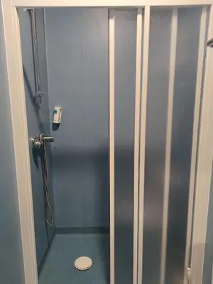 a shower stall with a toilet in a bathroom at TEIRABOA BASE CAMP in Arzúa