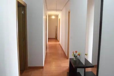 a hallway with white walls and a long corridor at La Casa de Lines in Monforte de Lemos