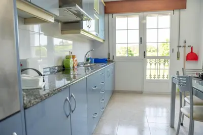 a kitchen with blue cabinets and a counter top at Apartamento Ultreia in Palas de Rei