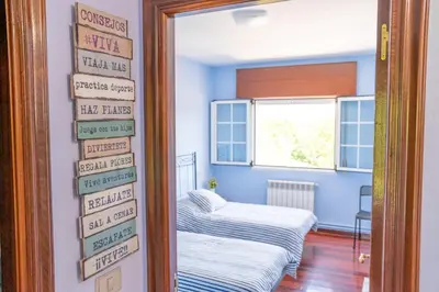 a room with a bed and a door with signs on it at Apartamento Ultreia in Palas de Rei
