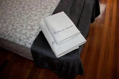 a stack of towels sitting on a bed at El piso de Manuela VUT-CO-004057 in Padrón