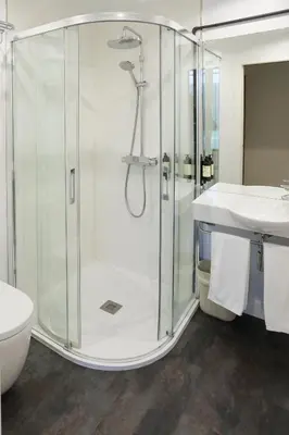 a bathroom with a glass shower and a sink at Hotel Roma in Sarria