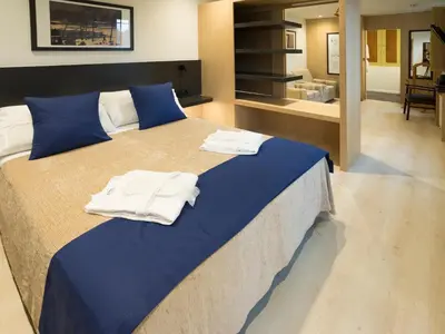 a bedroom with a large bed with towels on it at Hotel Roma in Sarria