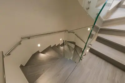 a glass staircase in a room with wooden floors at A Casa do Latoneiro in Caldas de Reis