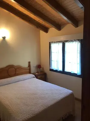 a bedroom with a bed and a window at El Pajar in San Ciprián