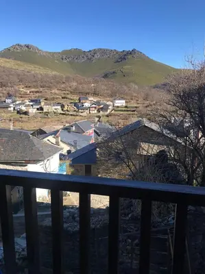 a view from the balcony of a house with mountains in the background at El Pajar in San Ciprián