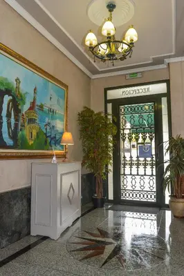 a lobby with a door and a painting on the wall at Hostal Linares in Ribadeo