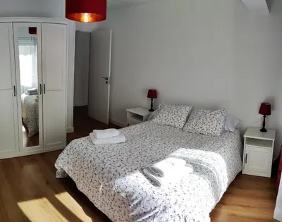 a bedroom with a bed with towels on it at CARMELA in Santiago de Compostela