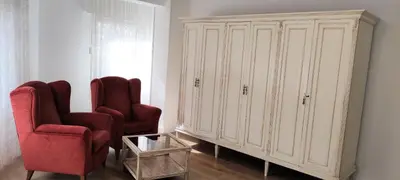 a living room with two chairs and a cabinet at CARMELA in Santiago de Compostela