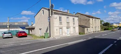 an old building on the side of a street at Casa entera en Nois-Foz in Nois