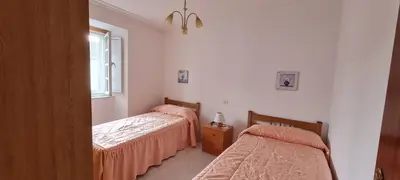 a bedroom with two beds and a window at Casa entera en Nois-Foz in Nois