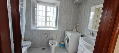 a white bathroom with a toilet and a sink at Casa entera en Nois-Foz in Nois