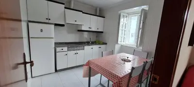 a kitchen with white cabinets and a table and a window at Casa entera en Nois-Foz in Nois
