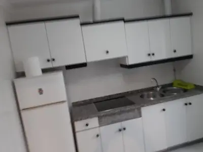 a white kitchen with white cabinets and a sink at Casa entera en Nois-Foz in Nois