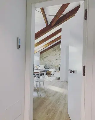 a hallway with a dining room with a table at Apartamentos Puerto Norte - Apto 1 in Puerto de Vega